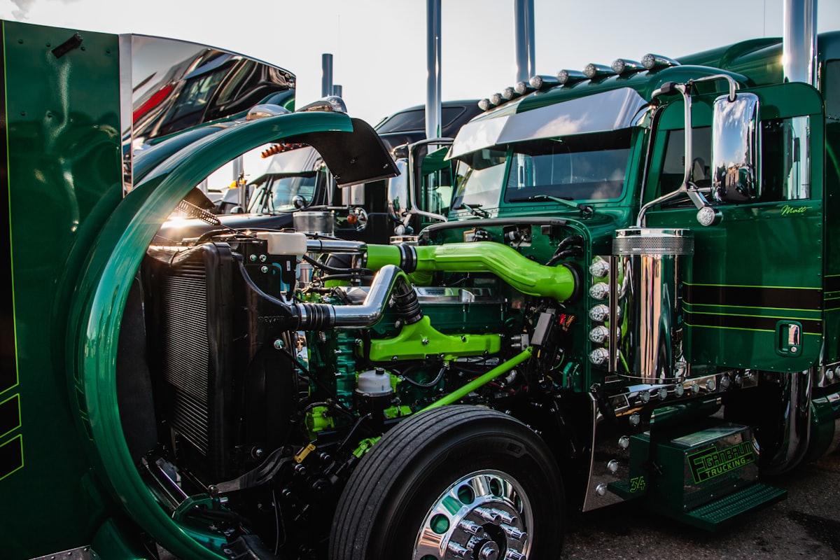 Close-up of a green American Kenworth cab and engine bay.